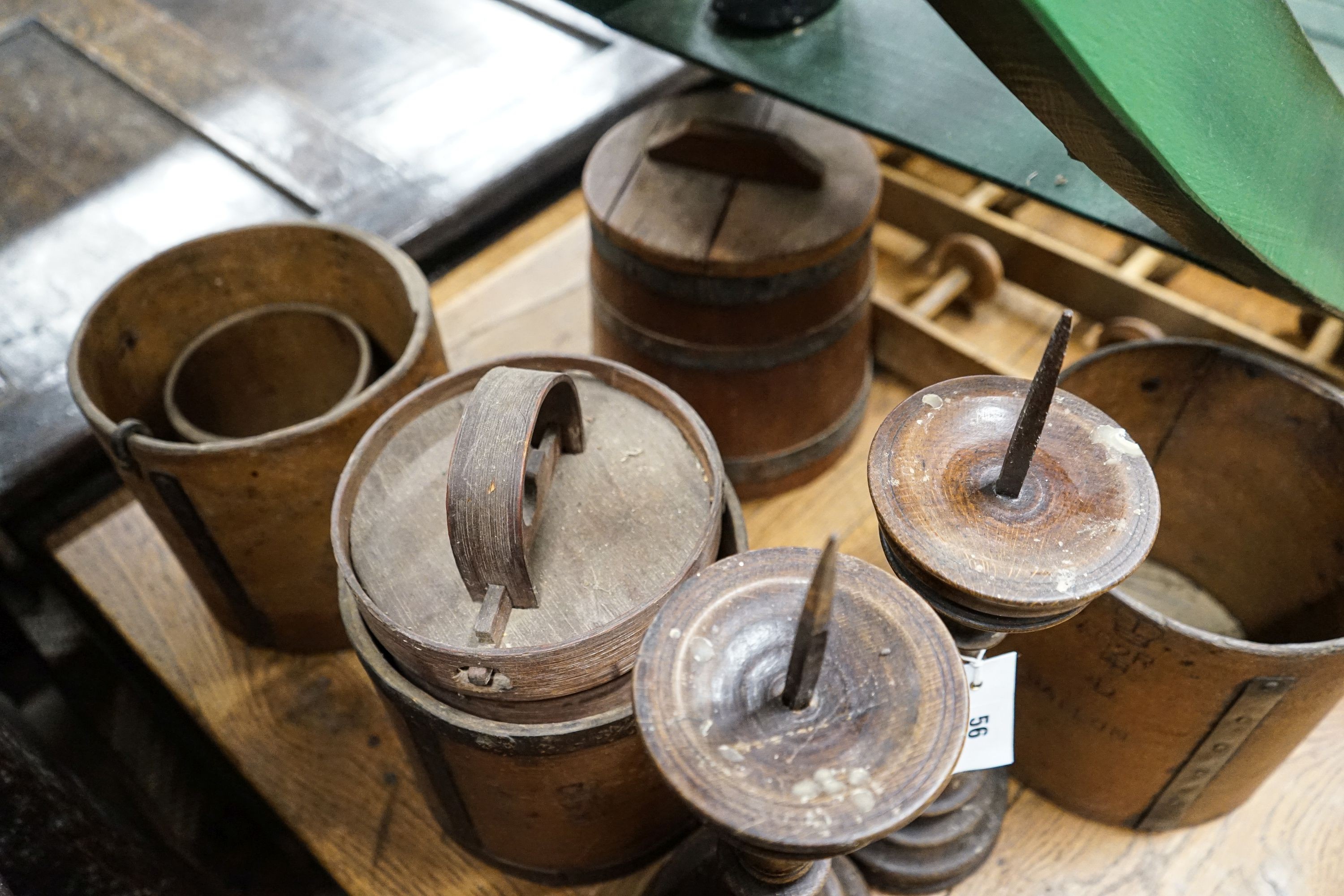 Six assorted treen measures and butter pails, a pair of pricket candlesticks, height 37cm and three faux bamboo coat hooks